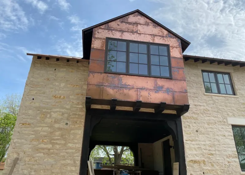 Copper metal panel facade on a stone building for Roof Repair in Erwin