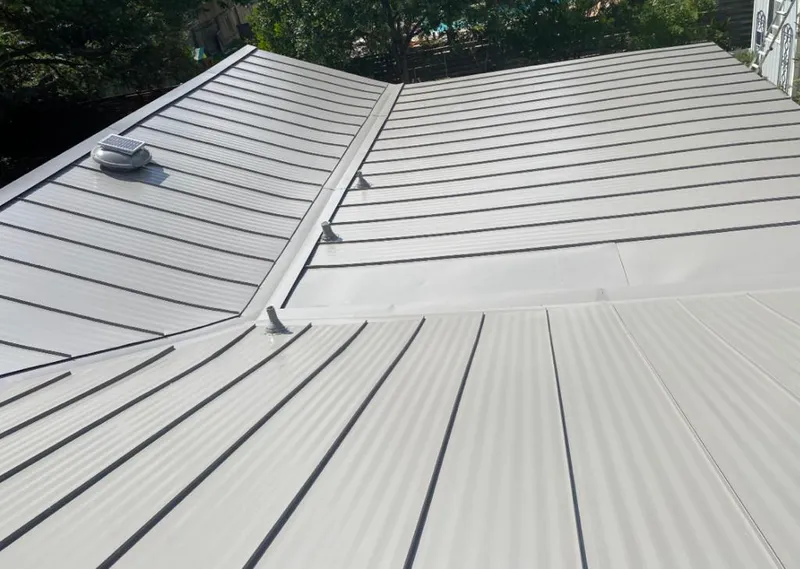 Solar attic fan installed on a metal roof for Roof Ventilation in Erwin